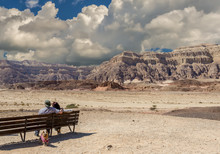 Couple Of Happy Seniors Looking At The Valley Of Geological Timna Park And Dry Riverbed, 25 Km North Of  Eilat, Israel