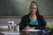 Portrait of a black female teacher at her desk 