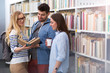 © pikselstock - University students working in the library at campus