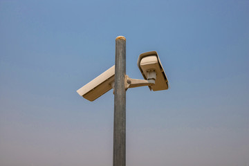 CCTV camera in security system in urban city with sky background in security concept