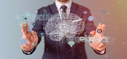 Wall Mural - businessman holding a 3d rendering artificial intelligence concept with a brain and app
