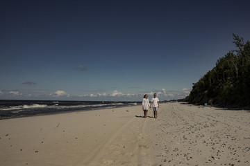 Wall Mural - Summer time on beach and two lovers 