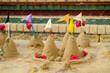 Group of sand pagoda on temple in Songkran Festival, Sand Pagoda is an ancient tradition of the ancient people. And these sand pagodas are also decorated with flags and flowers. 