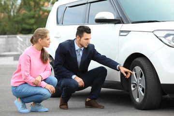 Sticker - Salesman showing new car to customer outdoors