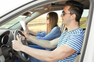 Sticker - Beautiful young couple with map in car