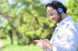 © Teodor Lazarev - Young man listening to his favourite music, enjoying a wonderful day in the park or forest