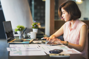 Portrait of beautiful young woman working in the office.	