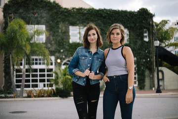 Attractive Girls Modeling in Front of Ivy Walled Building