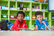 © weedezign - Two boy kid lay down on floor and reading tale book  in preschool library,Kindergarten school education concept