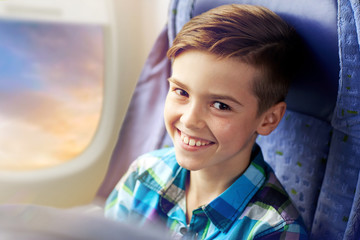 Sticker - transport, tourism, road trip and people concept - happy boy travelling by plane over porthole background