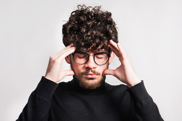 Wall Mural - Portrait of a young man in pain in a studio.