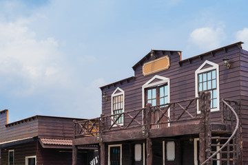 Building ventage cowboy style on blue sky background.