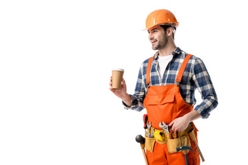 Sticker - Smiling builder in orange overall and tool belt drinking coffee isolated on white