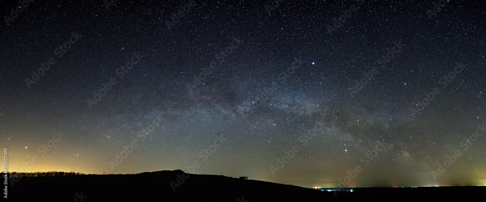 Stars of the Milky Way galaxy in the night sky above the skyline ...