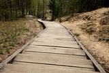 Fototapeta  - An old wooden staircase with a big mountain in the forest. Photo from the top