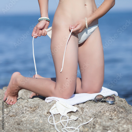 Womans Body Parts On Sticking Out Of Sea Rock Stock Photo Adobe Stock