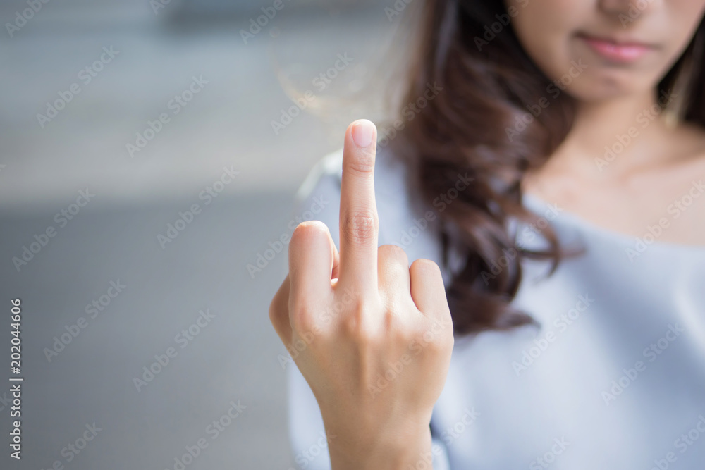 rude woman hand giving middle finger to you; negative angry upset failed asian woman showing offensive, rude, f, vulgar middle finger hand gesture; asian woman young adult hand model - obrazy, fototapety, plakaty 