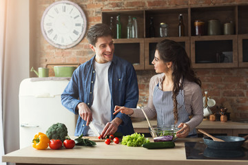 Happy couple cooking healthy dinner together