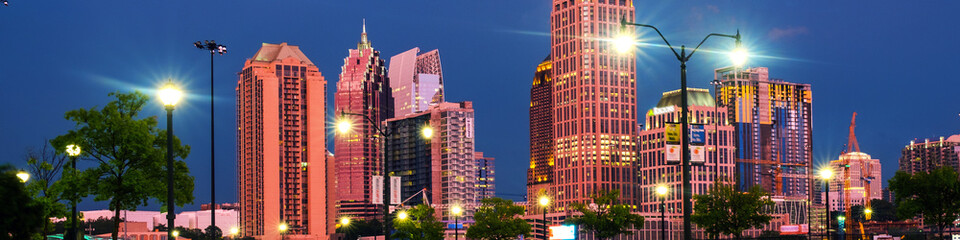 Poster - Illuminated Midtown in Atlanta, USA at night. Car traffic, illuminated buildings and dark sky