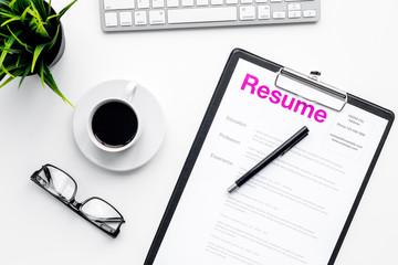 Poster - Create resume. Resume on white work desk with coffee, glasses, keyboard top view