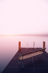 Empty footbridge with a bench on a lake Altausseer at sunrise