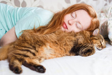 Young Redhair Woman Sleeping With Cat.