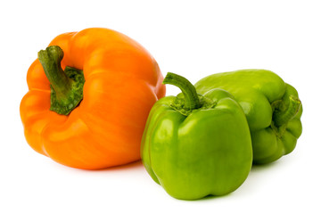 Wall Mural - One orange pepper and two green on a white isolated.