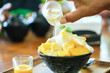 Korean shaved milk ice topped by fresh mango. Mango bingsu.