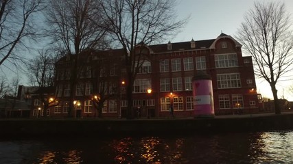 Poster - cruising along amsterdam houses at the canals in the netherlands at sunset