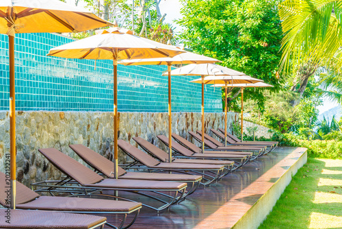 Beautiful Umbrella And Chair Around Swimming Pool In Hotel