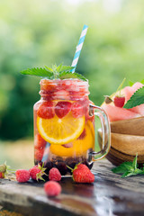 Wall Mural - Fresh fruit and berry water in glass jar. Summer drinks