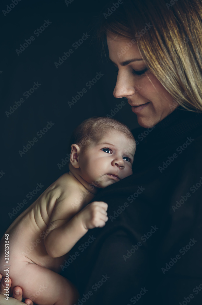 Nudist baby girls Nude baby girl posing in her mother's arms on black background Stock Photo  | Adobe Stock