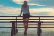 © astrosystem - Female looking at the distant ocean / sea view.