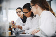 © Maskot - Female chemistry teacher explaining to young multi-ethnic students in laboratory