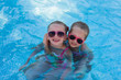 © viclin - Two little funny girl in the pool on holiday