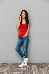 Sticker - Full length image of Happy brunette woman in casual clothes