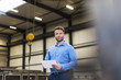 © Westend61 - Man with tablet on factory shop floor looking around