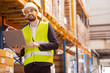 © zinkevych - Professional occupation. Smart logistics manager smiling while working in the big storehouse