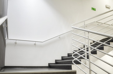 Modern empty staircase with white wall as to be found in an office, hospital or an apartment.