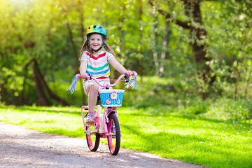 Wall Mural - Child on bike. Kids ride bicycle. Girl cycling.