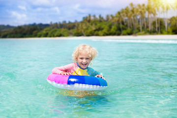 Wall Mural - Child on tropical beach. Sea vacation with kids.