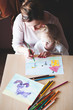 © Przemek Klos - Mom with little daughter drawing a colorful pictures using pencil crayons