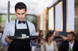 disgruntled waiter holding serving tray with tips
