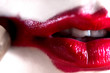© Yury - The girl paints her lips with red lipstick, close-up.