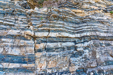 Compressed Rock Layers Formation In Various Colors And Thicknesses, On South Central Coast Of The  Mediterranean Island Crete, Greece. Nature And Geological Science Concept
