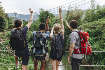 Wall Mural - Group of friends hiking through a jungle