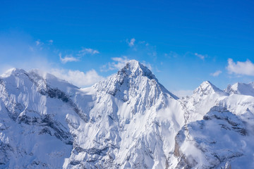 Stunning panoramic view of the Swiss Alps from the top of the Schilthorn mountain in the Jungfrau region of the country