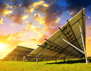 Solar energy panels in the meadow at sunset.Sustainable resources.