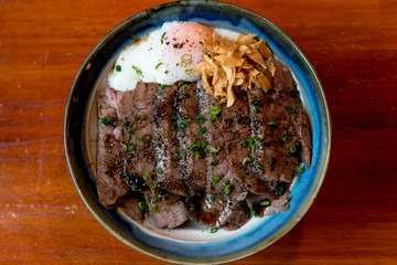 Wall Mural - Beef Steak Donburi with egg and fried garlic