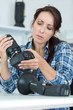 © auremar - female photographer adjusting a camera tripod